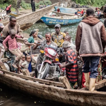 Congolese displaced fleeing the area of Minova board with their belongings boat leaving the port of Nzulo on January 21, 2025 to seek shelter in Goma. Photo by JOSPIN MWISHA/AFP via Getty Images.